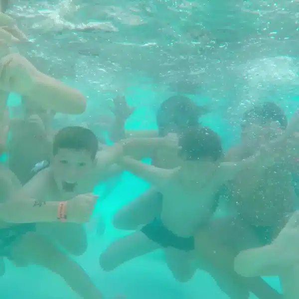 Children playing in an underwater pool.