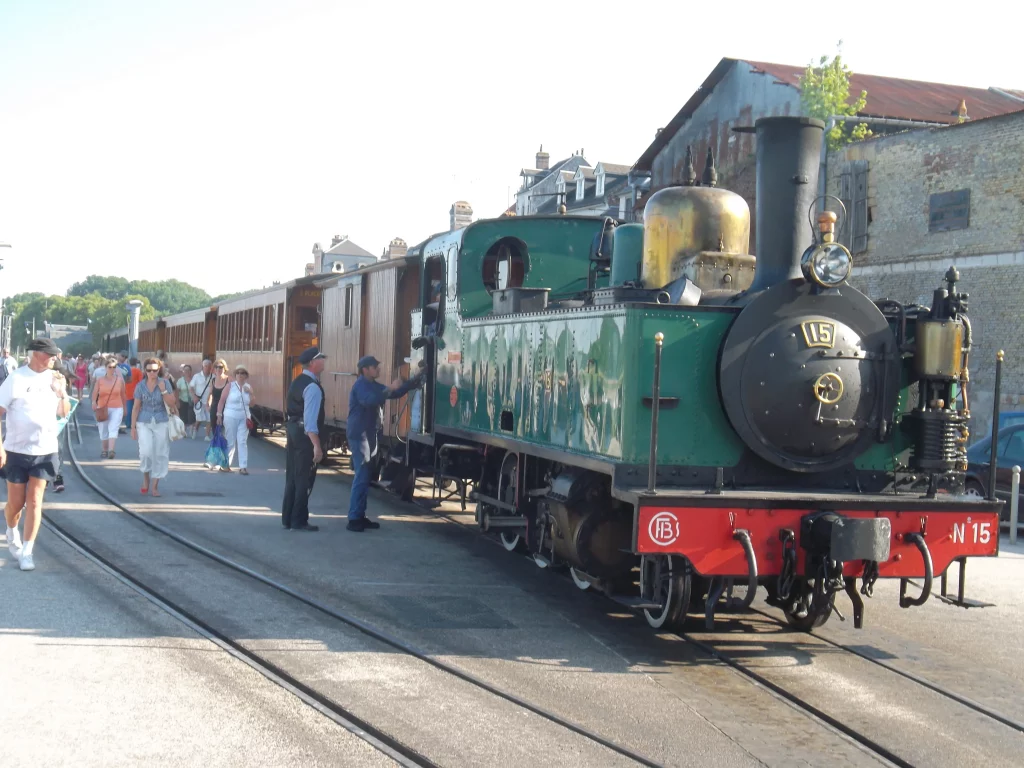 Locomotive à vapeur avec passagers à la gare.